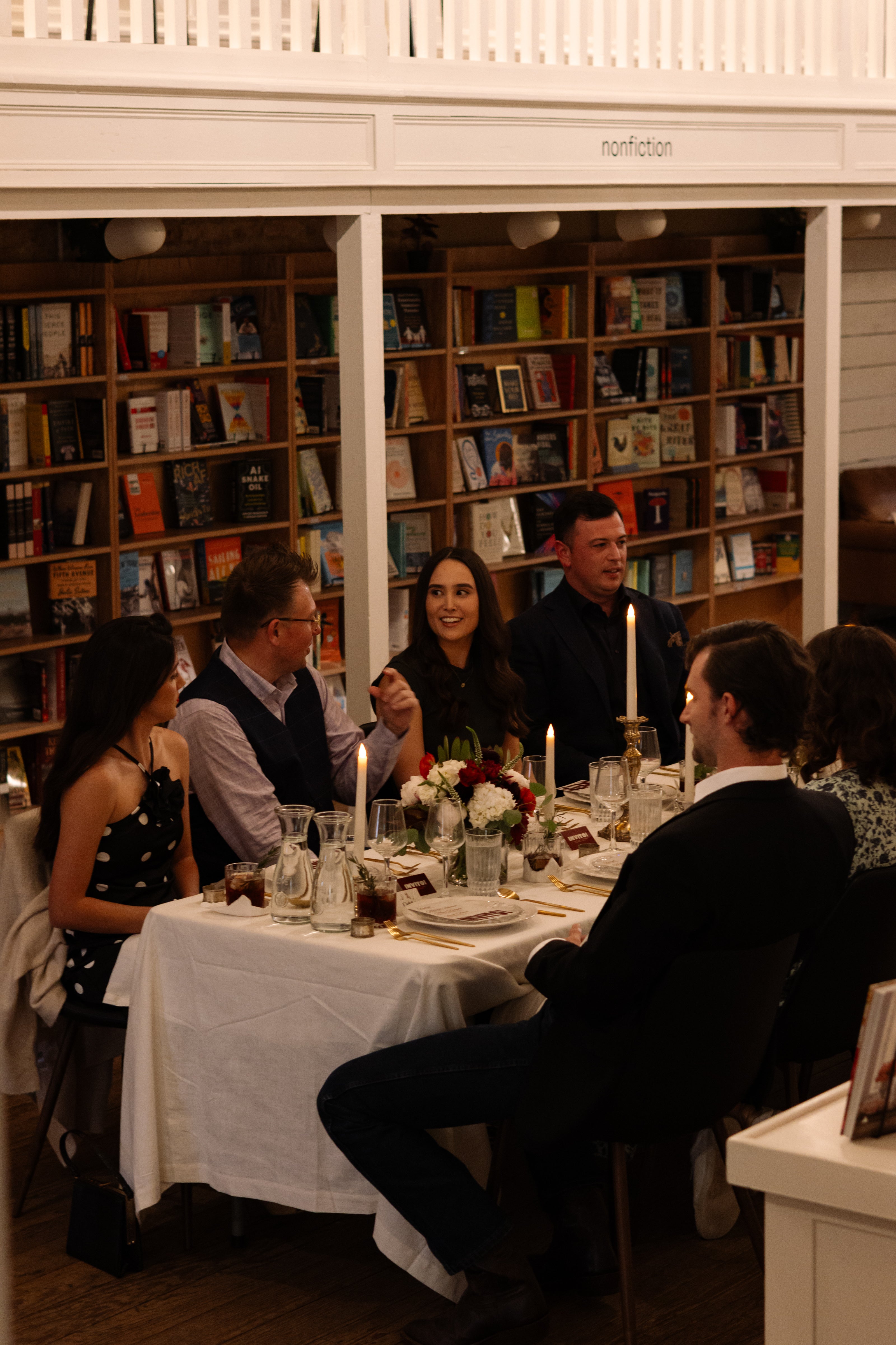 A group of Christian singles at an immersive dining experience in an elegant bookstore. 