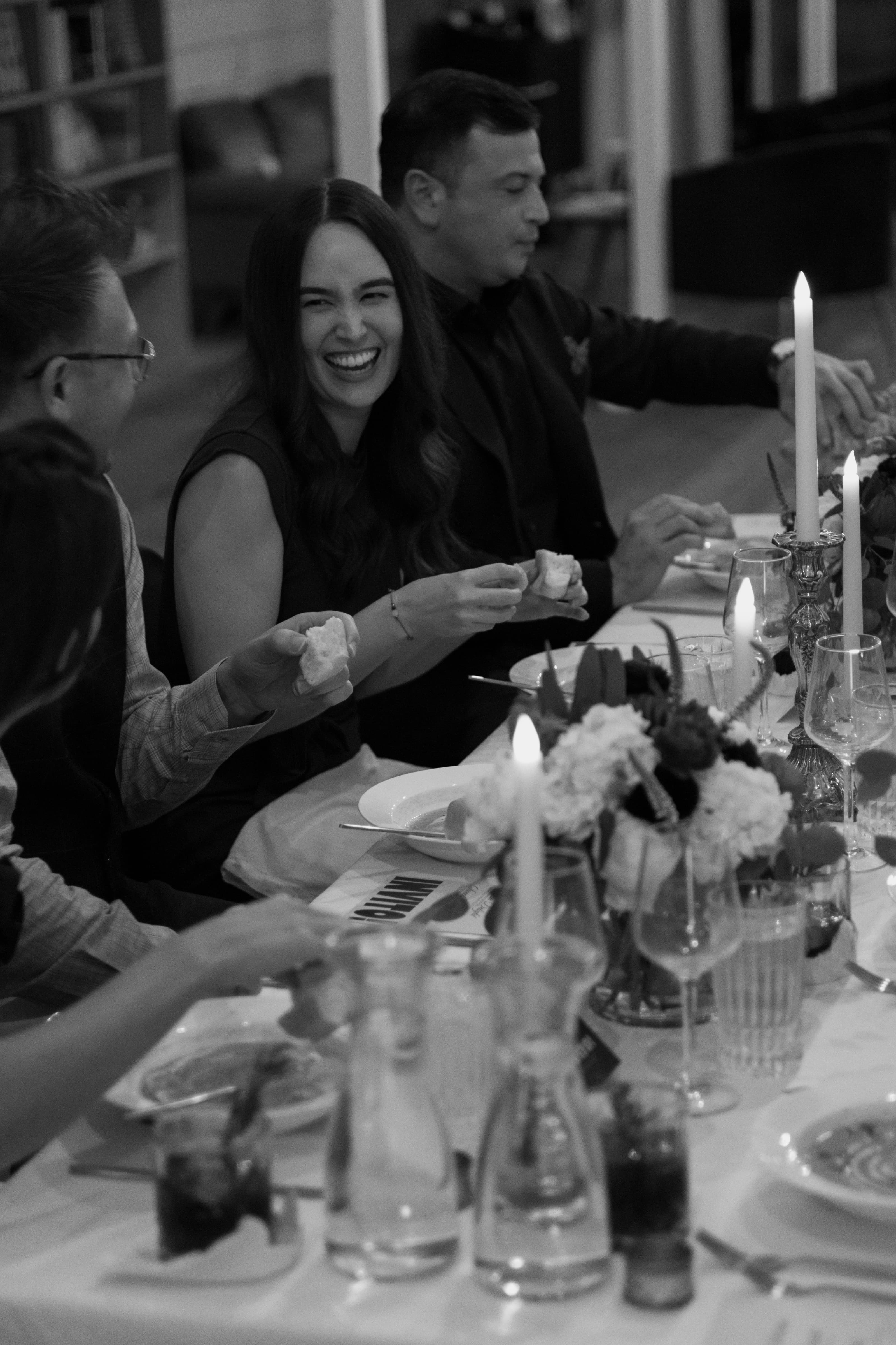 Woman joyfully laughing at an Invito group dinner date. 